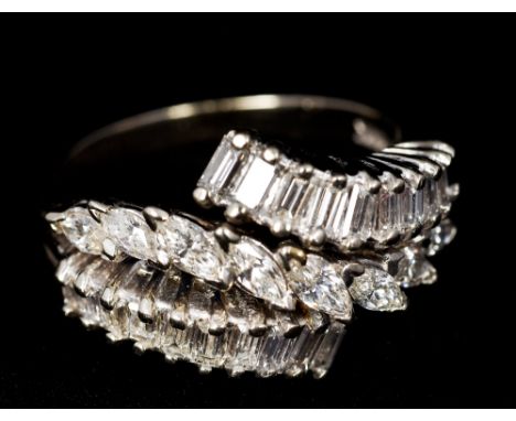 A 14 K white gold diamond ringSet with two rows of baguette cut diamonds flanking a row of marquise cut diamonds.  1.25 cm hi