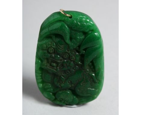 A LARGE CHINESE CARVED GREEN JADE PENDANT. 2.25ins