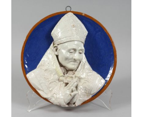 A GOOD DELLA ROBBIA TYPE CIRCULAR PLAQUE, blue background, a Pope in relief 12ins diameter.