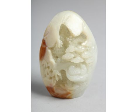 A CHINESE CARVED WHITE JADE PEBBLE. 2.25ins.