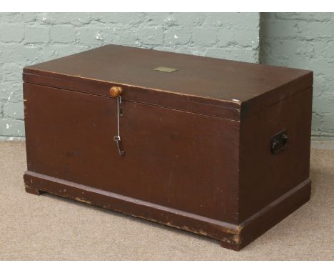 An antique pine lockable trunk with key.