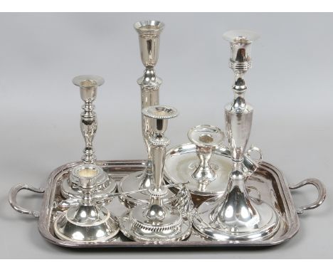 A collection of silver plate to include serving tray, candlestick, candle snuffer and chamber stick.