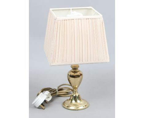 A brass base table lamp.