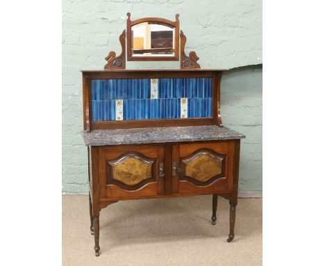 A Victorian mahogany and walnut marble top wash stand with tile back and mirror.