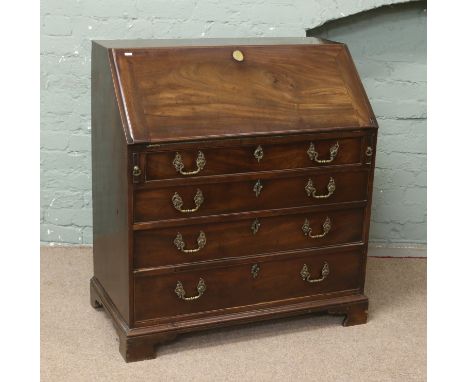 A Georgian mahogany fully fitted fall front bureau raised on bracket feet.
