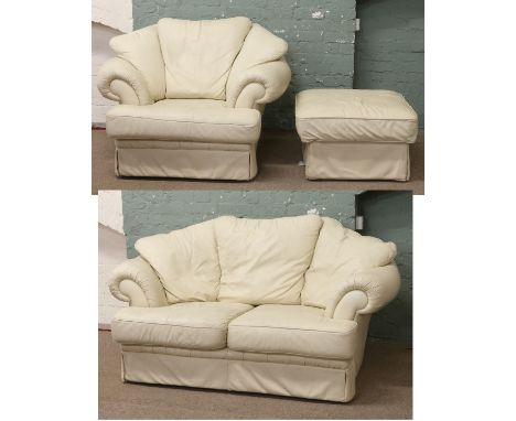 A cream leather three piece suite, consisting of two seater sofa, arm chair and foot stool.