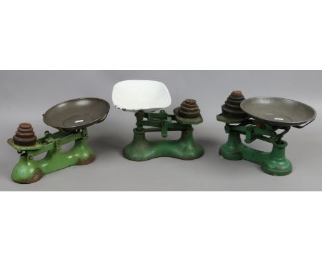 Three sets of painted cast iron kitchen scales with graduated weights, one with enamel bowl.