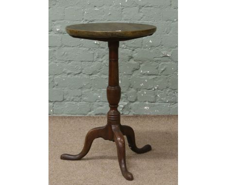 An antique mahogany tripod wine table with later top.