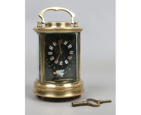 A French cylindrical brass 8 day carriage clock. With unusual black enamel dial decorated with trailing leaves and having Rom