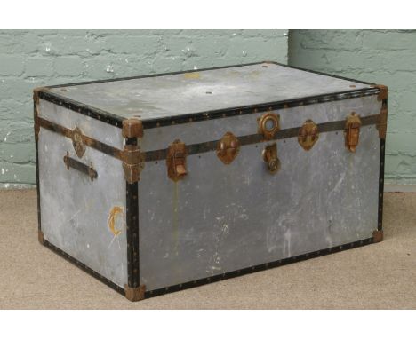 A vintage galvanized metal travel trunk.