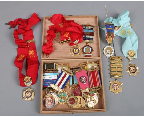 A cigar box containing an assortment of gilt metal and enamel Buffalo's lodge medals. 