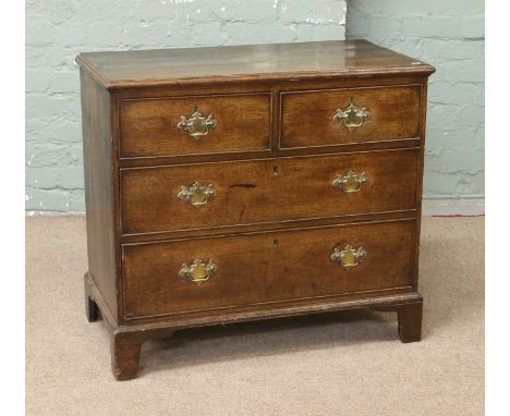 A Georgian oak two over two chest of graduated drawers raised on bracket feet.   Condition Report. To be used as a guide only
