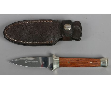 A German Boker 515 boot knife with hardwood scales and in leather sheath. 