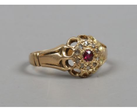 An 18ct gold ruby and diamond cluster ring. Size M.