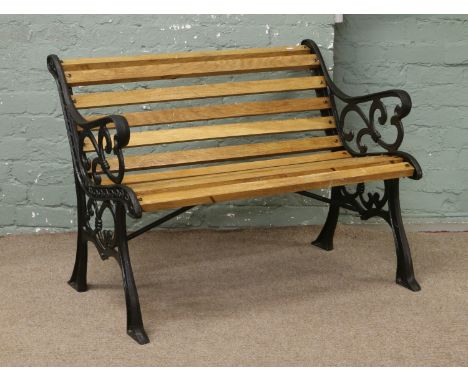 A cast iron garden bench with oak slats.