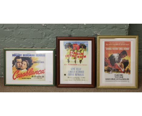 Three framed film posters for vintage films, after originals including Singing in the Rain, Gone with the Wind and Casablanca