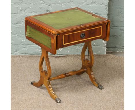 A small yew wood leather top sofa table with drawer, raised on lyre supports.