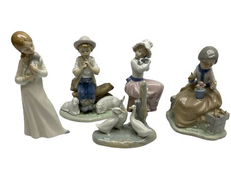 Group of Nao figures to include Friends and Flowers, boy sitting on a log playing the flute with two sheep by his feet, geese