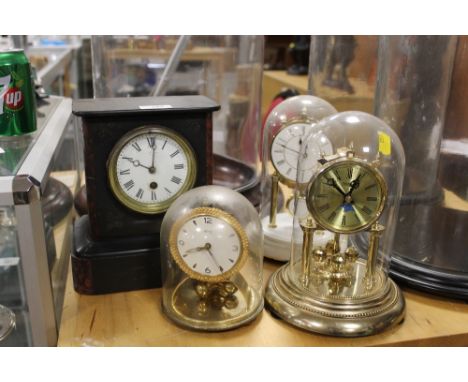 A SMALL SLATE MANTEL CLOCK TOGETHER WITH THREE DOME TOPPED CLOCKS