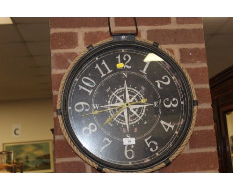 A MODERN WALL HANGING COMPASS WALL CLOCK 