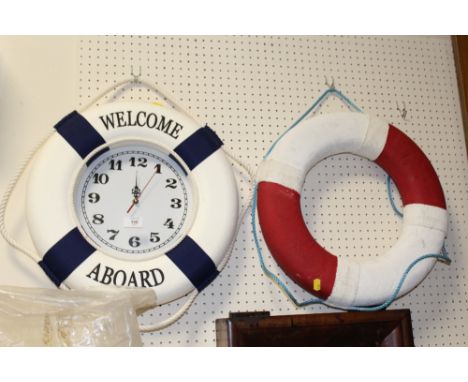 A WELCOME ABOARD WALL HANGING CLOCK TOGETHER WITH A WALL HANGING LIFE RING  