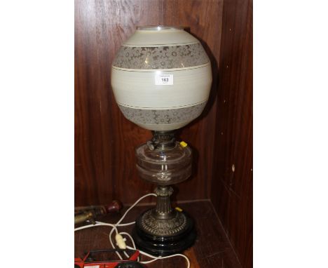 A CONVERTED BRASS AND GLASS OIL LAMP AND SHADE 