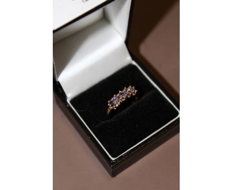 A LADIES 9CT GOLD DRESS RING SET WITH FIVE BLUE STONES  