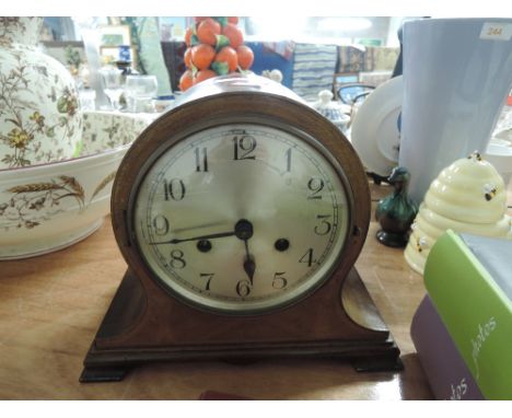 A vintage over mantle clock with a Victorian style body and chime
