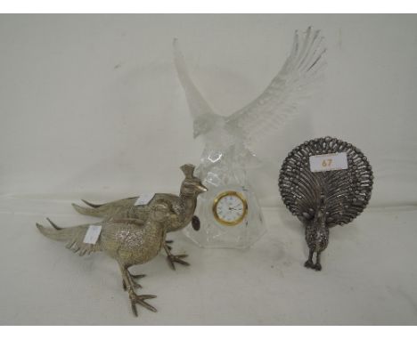 A selection of vintage cast display pieces peacock birds and glass eagle clock
