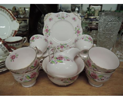 A part tea dinner coffee service by Tuscan in baby pink with foliate decoration