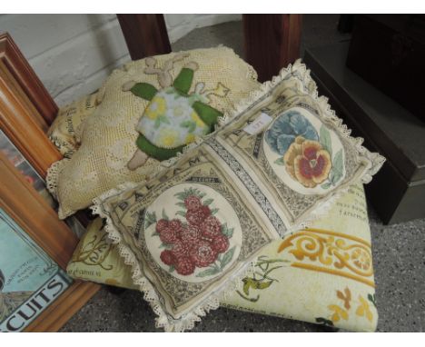 A vintage footstool and similar style pillows and cusions
