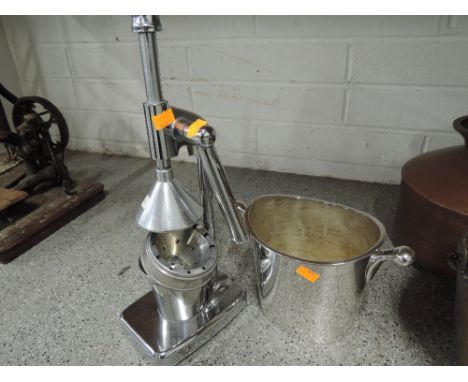 An orange or other fruit press and matching ice bucket in a chrome style