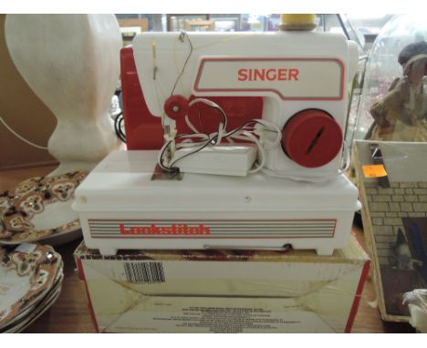 A vintage childrens sewing machine by singer with original box 