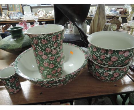 A vintage wash jug and bowl vanity set in a chintz style pattern 