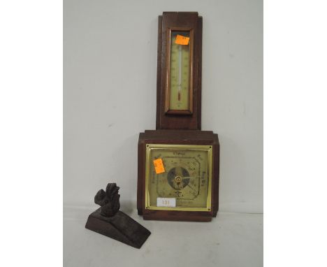A vintage wall mounted barometer, a thermometer and a cast door wedge