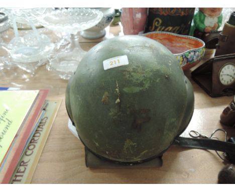A vintage military helmet possibly aviation or tank related Vietnam style