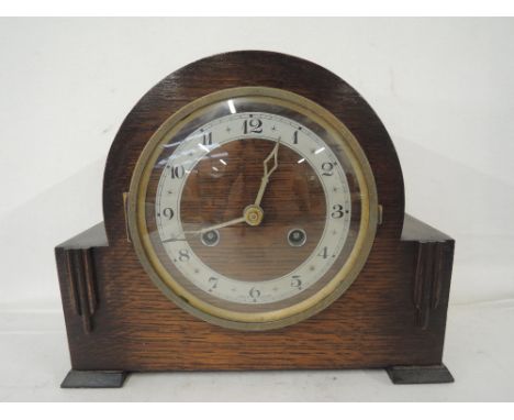 An oak mantle clock with a Georgian style and chime