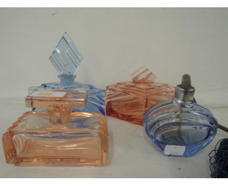A selection of vintage Art Deco style heavy cut glass perfume bottles blue and pink glass