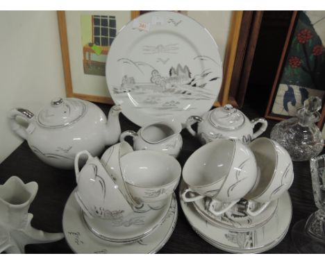 A part tea dinner coffee service un marked white with silver lustre decal