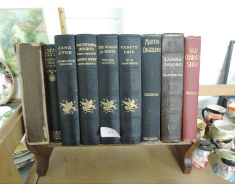 A vintage treen trough book shelf with vintage volumes Dickens, Bronte etc