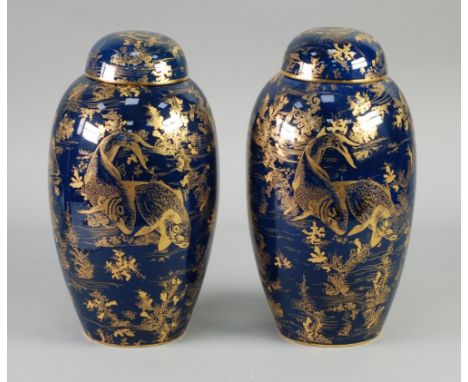 AN ATTRACTIVE PAIR OF CIRCA 1920's WILTSHAW AND ROBINSON CARLTON WARE POTTERY OVOID VASES, with domed covers, the Royal blue 