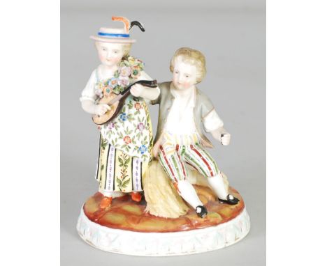 SITZENDORF, GERMAN PORCELAIN GROUP, modelled as a boy sat on wheat sheaves beside a girl playing a lute, on an oval, moulded 