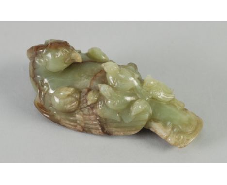 A GOOD CHINESE QING DYNASTY GREEN AND RUSSET JADE CARVING of a phoenix with eight chicks, 4 1/4" (10.8cm) long 