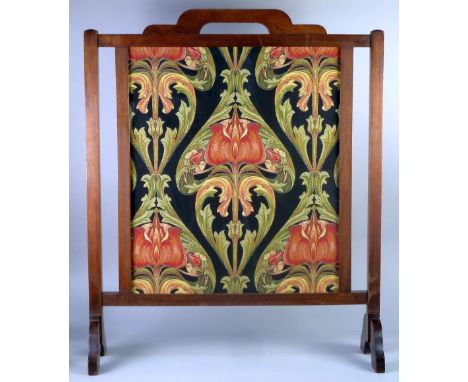 AN EDWARDIAN MAHOGANY FRAMED FIRE SCREEN, enclosing an Arts and Crafts machine work tapestry in the manner of William Morris,
