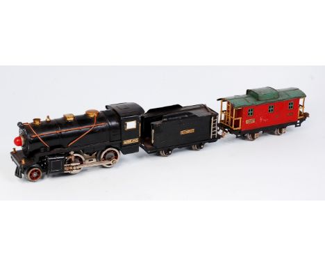 A Lionel No. 257 2-4-0 engine and 4 wheel tender together with a red 807 caboose (G)