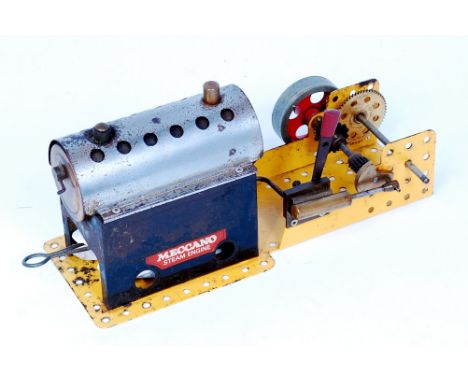 Meccano Horizontal Steam engine, comprising of tin housed boiler, with burner, powering a small spoked fly wheel, with revers