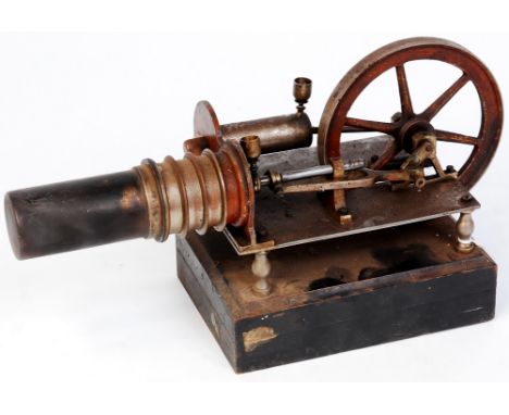 An early 20th century single cylinder hot air engine, with secondary cylinder, fitted with 2 oiler cups, powering a 4.5 spoke