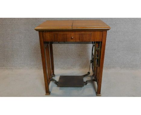 A vintage Frister and Rossman sewing machine in a fitted walnut side table. 80x70x50cm 