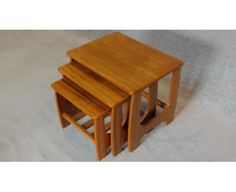 A vintage nest of three teak tables. H.43 W.52 D.40cm 