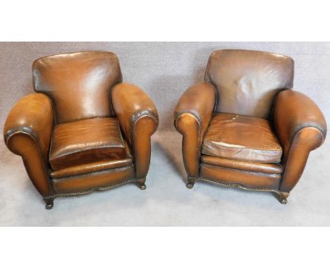 A pair of vintage beech framed leather club armchairs on cabriole feet to front and back. H.80 W.93 D.92cm (one cushion worn,
